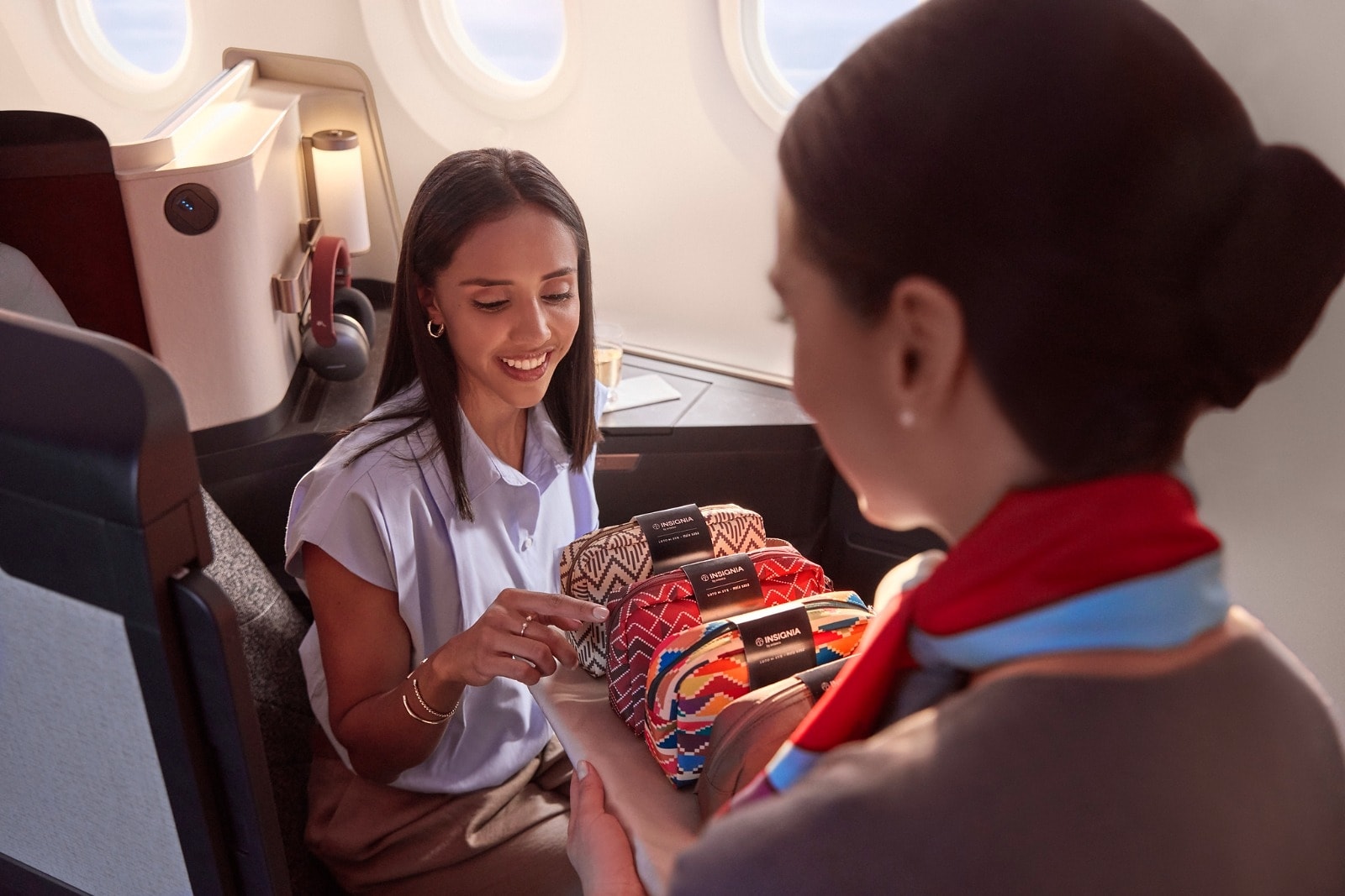 Avianca flight attendant serving passenger in business class cabin