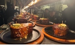 The scene at Perry’s on Flashback Friday — rows of cast-iron skillets headed to the dining room.