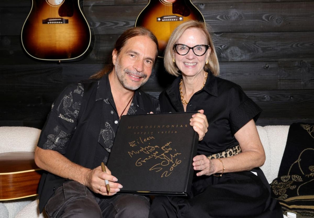 Sergio Vallín of Maná signs his book "Microsinfonías" for Miami Mayor Eileen Higgins at Gibson Garage Miami.