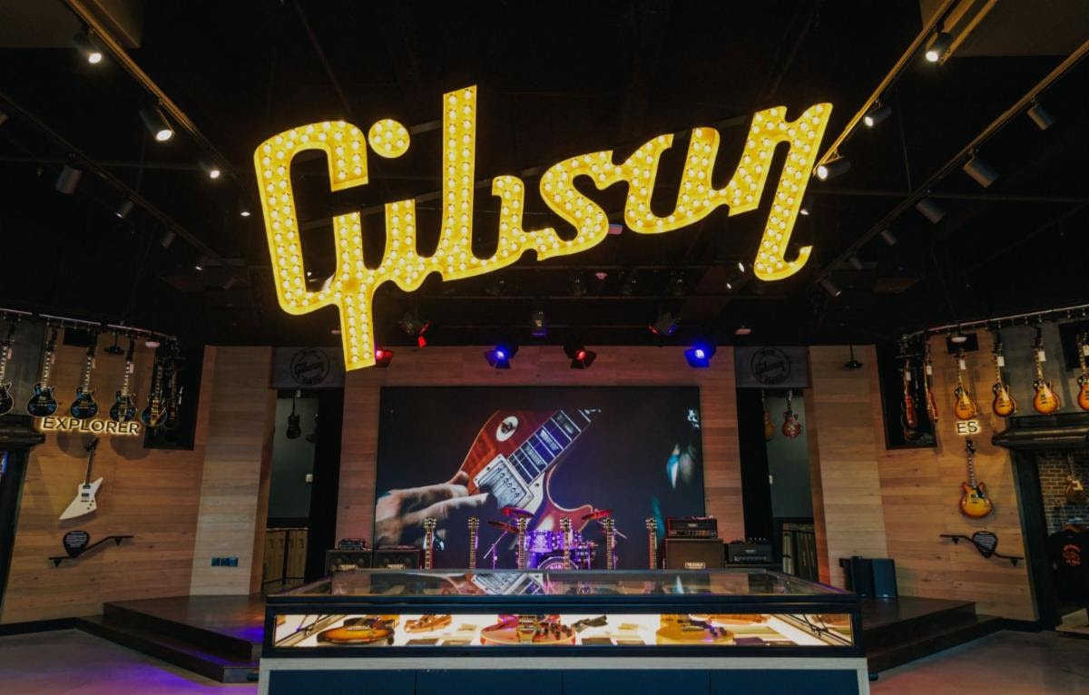 Gibson Garage Miami interior with iconic marquee sign and guitars on display
