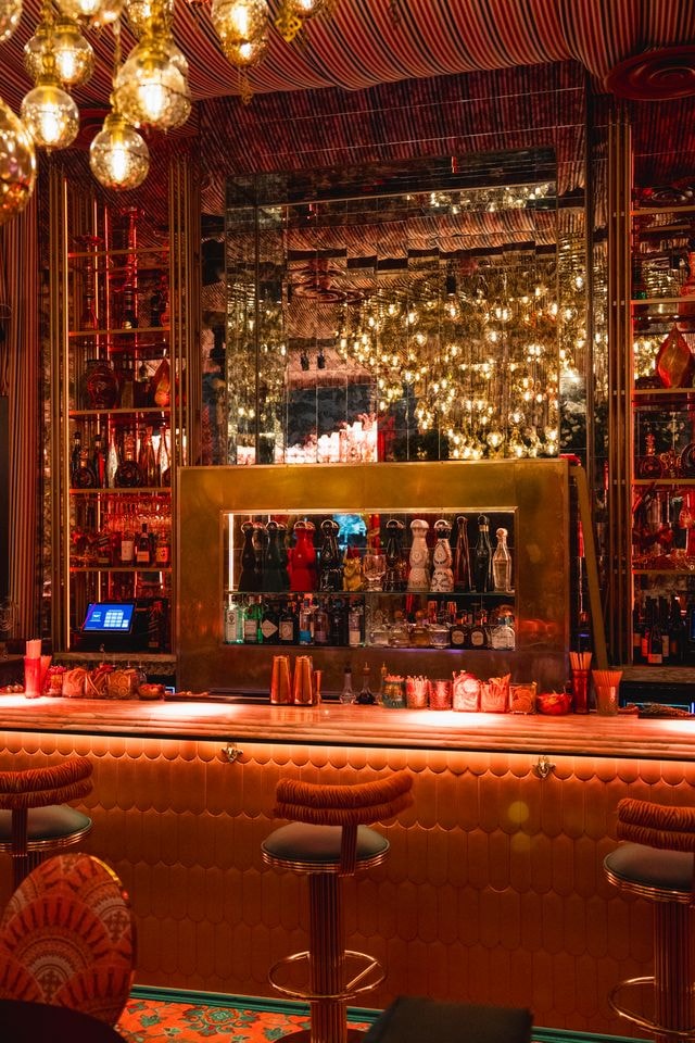 Moroccan-inspired bar interior at Habibi Miami with ornate lanterns, rich textiles and warm amber lighting