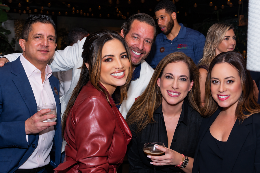 Group of five PROXHAUS members smiling at the Claudie launch event in Brickell