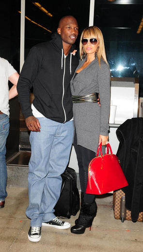 Chad Ochocinco and his new fiancee Evelyn Lozada arrive at Miami International Airport to board a flight to Madrid Miami, Florida