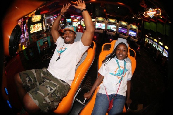 Cameron Wake with student at team service project Dave and Busters in Hollywood