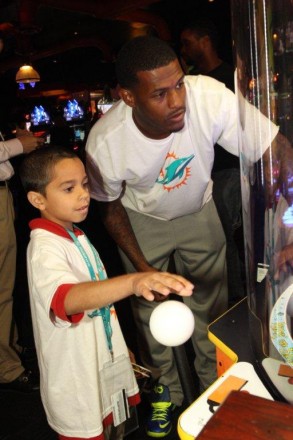 Mike Wallace with student at team service project Dave and Busters in Hollywood