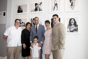 Pictured left to right; Felipe and Maria Barreda with son, Victor Barreda (front), St. Jude patient; Nigel Barker, Photographer and Host of The Face on Oxygen Network; Belkys Nerey, WSVN-Channel 7 Anchorwoman; and Chris Molho, General Manager, Village of Merrick Park pose for a photo in front of Barker's new photo exhibit at 'In the Now @ Village of Merrick Park.'