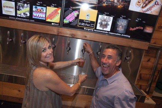 Patrons enjoying the one of a kind Beer wall (BurgerQ)