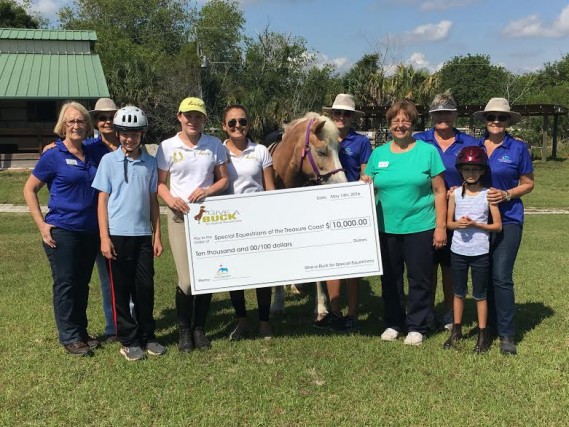 GAB co-founder Isabel Ernst and GAB Young Ambassador Sophia North present check to Special Equestrians of The Treasure Coast with volunteers