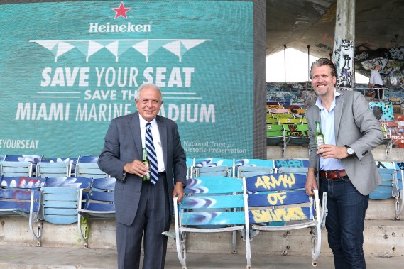 Mayor Tomas Regalado and Heineken's Ralph Rijks hoist the first removed seat at Miami Marine Stadium to celebrate the launch of Heineken's "Save Your Seat" Indiegogo crowdfunding campaign to support restoration of the historic structure. It marks the latest in Heineken's Cities campaign, which aims to make great cities even greater.