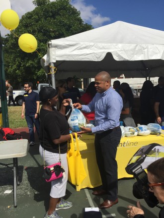 Miami City Commission Chairman Keon Hardemon and Brightline employees distributing more than 500 turkeys.