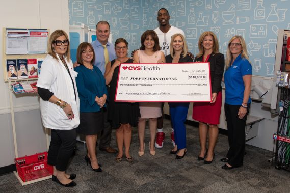 State Senator Annette Taddeo (front row center, pink dress), Miami Heat center Bam Adebayo (back row center, white shirt) and Mayra Boitel, vice president, CVS Health (front row right, red dress), along with CVS Health employees and representatives from the Juvenile Diabetes Research Foundation, attend a Project Health event on Thursday, September 19. Thursday’s event was one of 48 free health screenings taking place in the Miami area between now and the end of the year.
