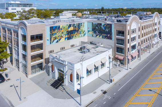 Aerial view of The Moore Building, in Miami Design District featuring billboard artwork by Adler Guerrier, in partnership with For Freedoms