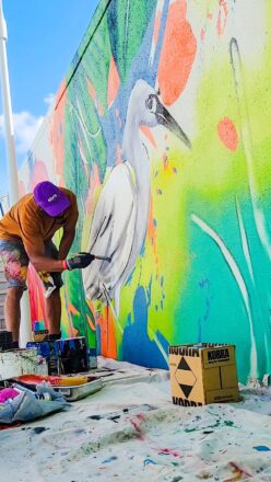 Contemporary artist Nate Dee with his “Natura Sound” mural at Miami Marriott Biscayne Bay.  Photo Courtesy Miami Marriott Biscayne Bay