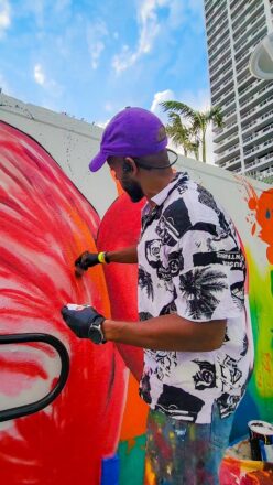 Contemporary artist Nate Dee with his “Natura Sound” mural at Miami Marriott Biscayne Bay.  Photo Courtesy Miami Marriott Biscayne Bay