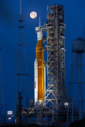The Artemis I SLS (Space Launch System) rocket and Orion spacecraft atop the mobile launcher at NASA’s Kennedy Space Center in Florida with a full Moon in the background on June 14, 2022. Credit: NASA/Cory Huston