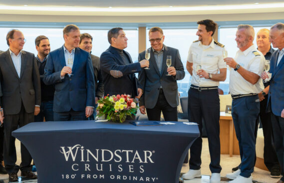 Mario Ferreira and Christopher Prelog raise a glass of champagne in celebration of the official handover of Star Seeker from the WestSEA shipyard to Windstar Cruises