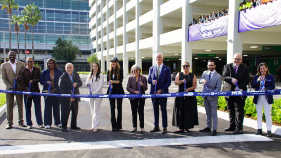 Miami-Dade County Mayor Daniella Levine Cava (center), Miami-Dade County Chief Operations Officer Jimmy Morales and County Commissioners Natalie Milian-Orbis and Danielle Cohen Higgins (left of center), MIA Director and CEO Ralph Cutié, Lemartec Senior Vice President Maira Suarez, and Florida State Rep. Juan Carlos Porras (right of center), and other local and MIA officials cut the ribbon for the new Ibis Garage.