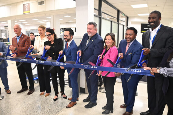 MIA, CLEAR, and TSA officials cut the ribbon for CLEAR’s eGates at MIA.