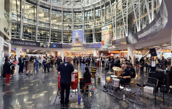 Willie Stewart and his drum team perform near gate D12 at MIA on February 12.