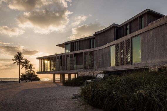 Board-form concrete is used on the exterior of the raised home.Photo credit: Ryan Lester, Architecture Sarasota
