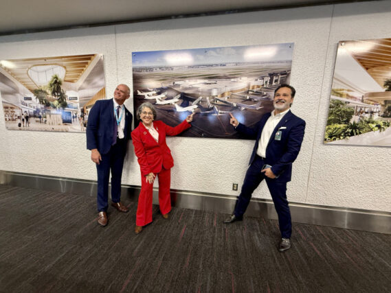 MIA Director and CEO Ralph Cutie, Miami-Dade County Mayor Daniella Levine Cava, and American Airlines Miami Hub Vice President J.C. Liscano unveil renderings of the future D60 at MIA.