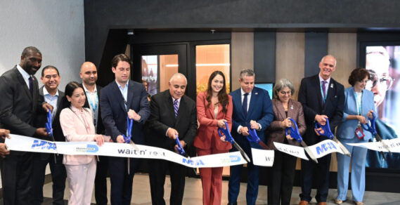Wait n’ Rest Founder Duilio Sanguineti (left of center), Miami-Dade County COO Jimmy Morales (center), County Commissioner Natalie Milian Orbis (right of center), County Tax Collector Dariel Fernandez (second right of center), Miami-Dade County Mayor Daniella Levine Cava (third right of center), MIA Director and CEO Ralp Cutie (second from right), and MIA Assistant Director of Business Development Sarah Abate (far right) cut the ribbon at the grand opening of Wait n’ Rest at MIA.