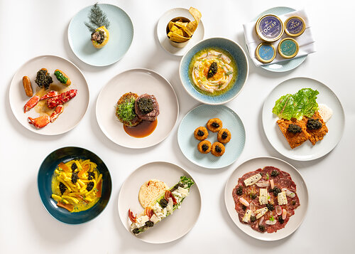 A spread of some of Ockap Caviar and Cuisine's signature dishes — including their Crispy Fried Chicken & Caviar, Caviar Croquetas, Beef Carpaccio, Charred Citrus Ceviche, and Ribeye & Caviar